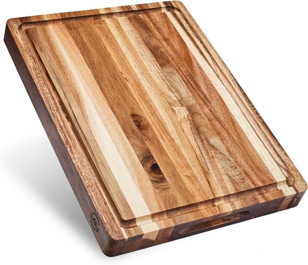 A large wooden cutting board made from acacia wood, featuring natural grain patterns and a juice groove around the edges for catching liquids. The cutting board has a solid, durable design, ideal for food preparation.